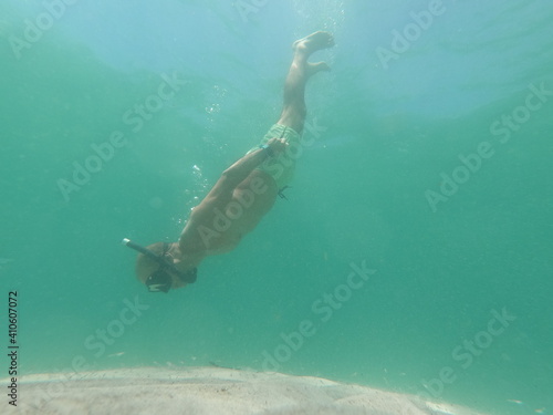underwater man snorkeling in the sea with crystal-clear waters concept of holiday relax summer beach diver in the sea © Enrique