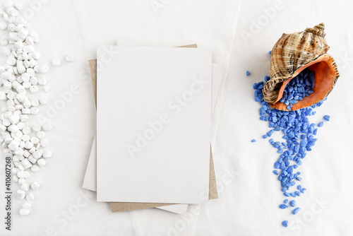 Fototapeta Naklejka Na Ścianę i Meble -  Fashionable stock stationery background - white map and seashells on a white table. Romantic background. Blank for an invitation card.