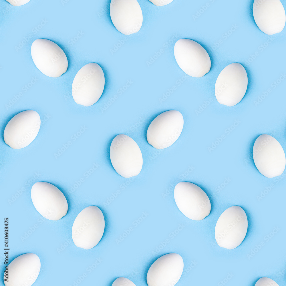 Two white wooden eggs seamless pattern on bright light blue background.