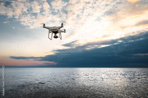 flying drone on a background of sea sunset