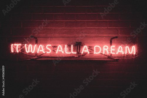 Brick wall with it was all a dream neon sign