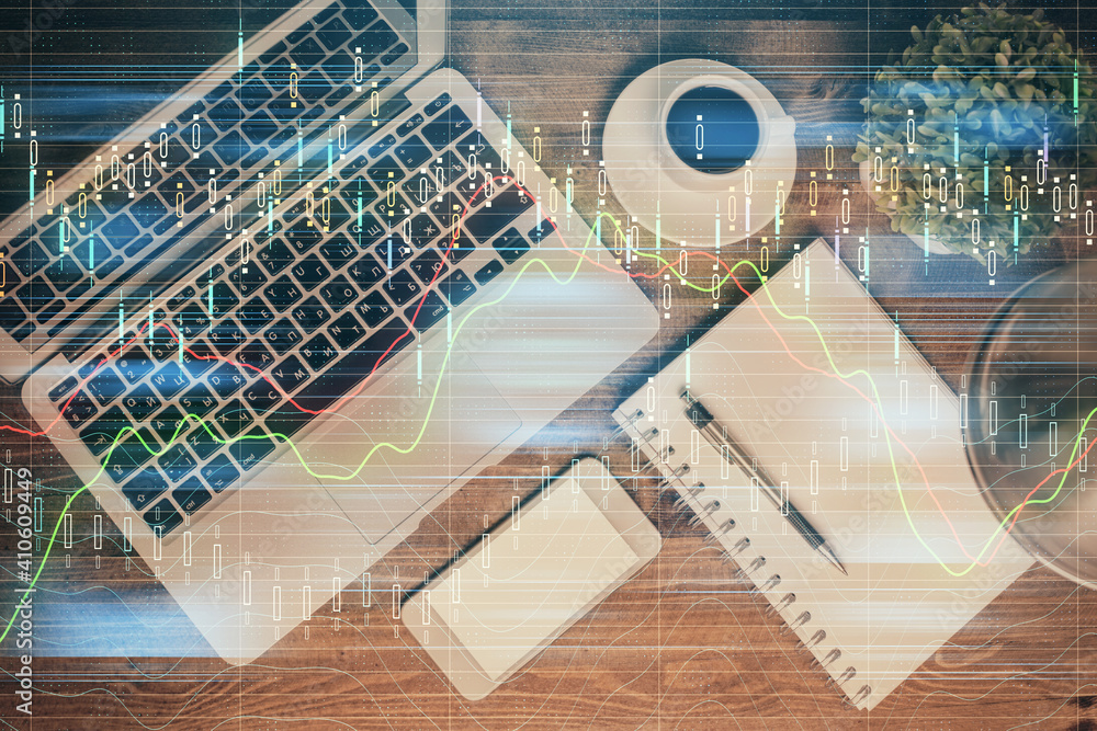 Financial market graph and top view computer on the desktop background. Double exposure. Investment concept. Financial market graph and top view computer on the desktop background. Double exposure. Investment concept.