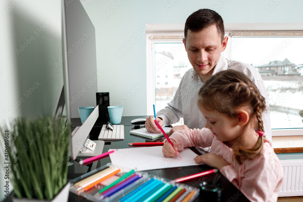 daughter draws with father sitting at the table daughter draws with father sitting at the table