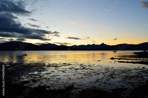 beautiful colours behind mountain range and in fjord as the sun is going down