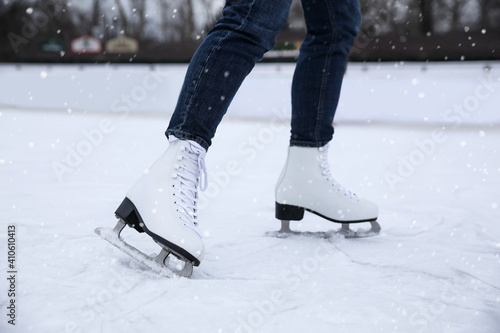 Woman skating along ice rink outdoors, closeup