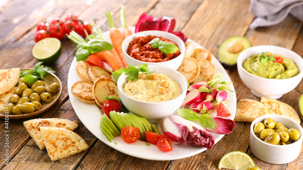 variety of fresh vegetables and dips