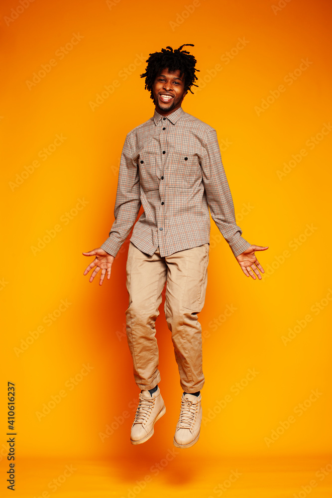 young handsome african american guy student posing cheerful and gesturing on yellow background, lifestyle people concept young handsome african american guy student posing cheerful and gesturing on yellow background, lifestyle people concept