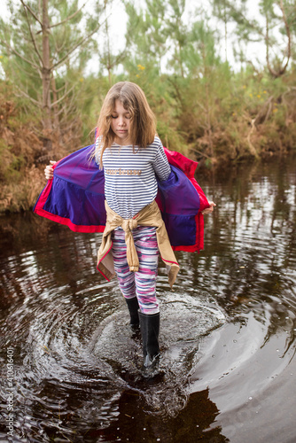 cute young girl having fun on flooded roads photo