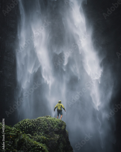 Man standing by a waterfall in Java