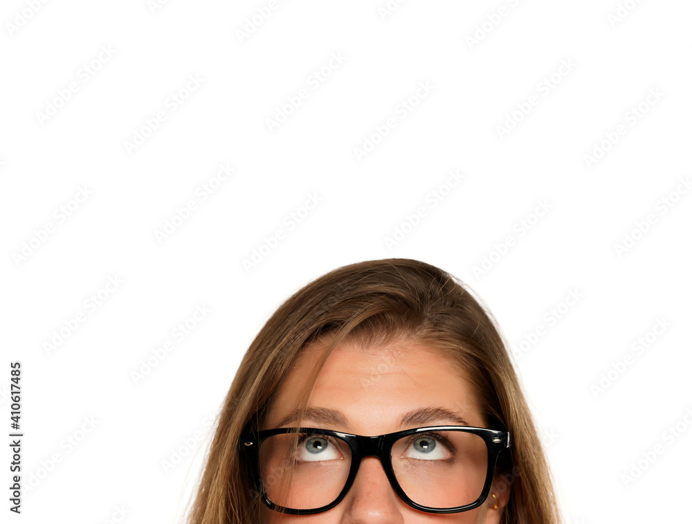 Half portrait of a young puzzled woman with eyeglasses