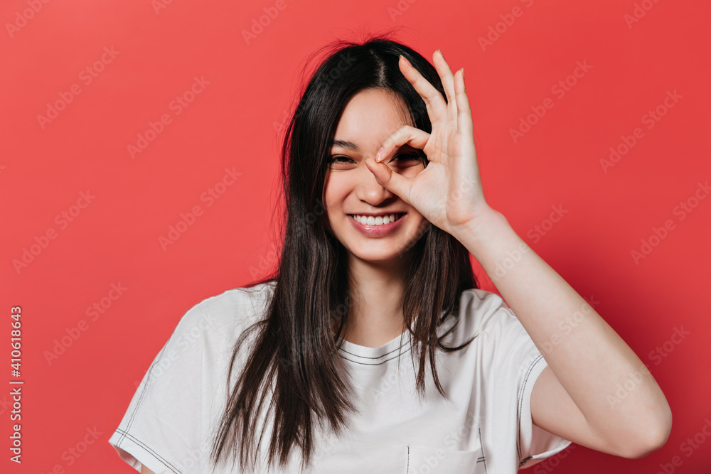 Naughty woman in white top laughs and shows OK sign Naughty woman in white top laughs and shows OK sign