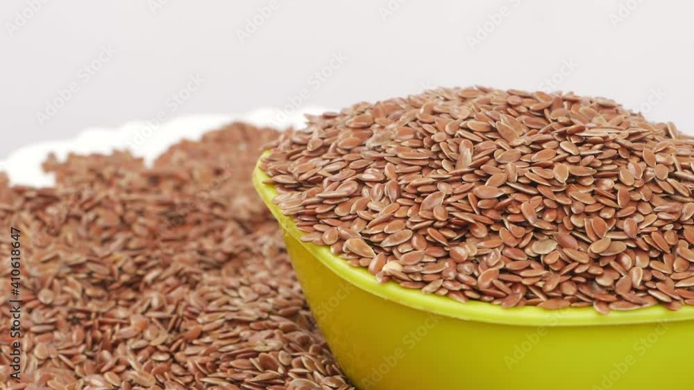 Close rotating shot of plastic bowl filled with flax seeds