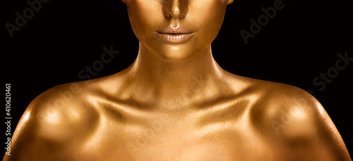 Fashion Gold Skin Beauty Woman Portrait. Face Model Golden Makeup. Gold Lips Make up and Shiny Body Paint over Black