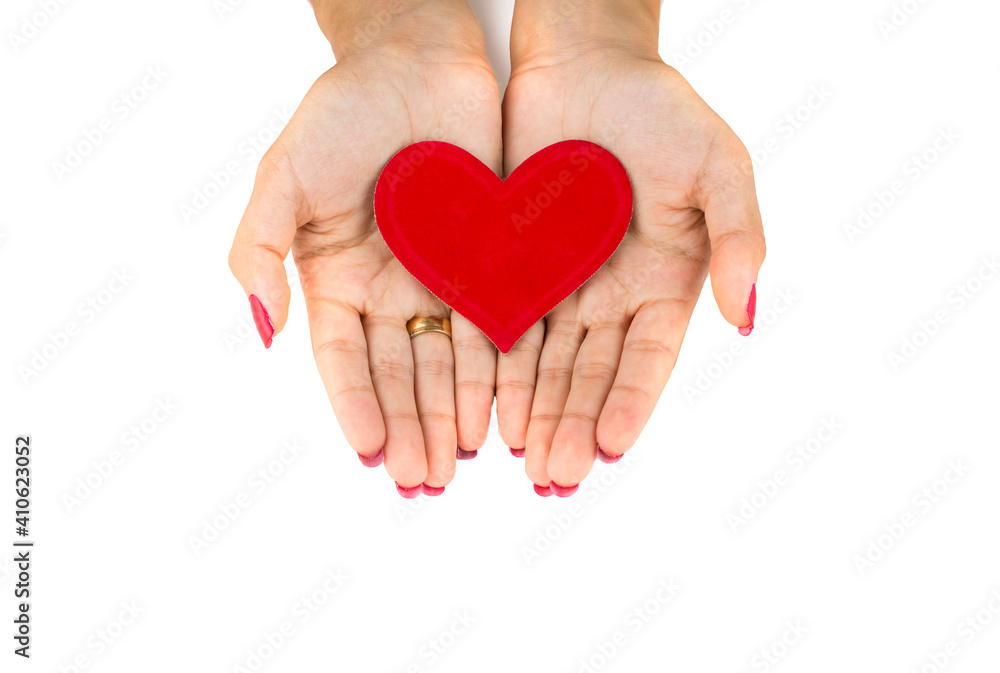 Woman hands holding heart figure made from red Woman hands holding heart figure made from red