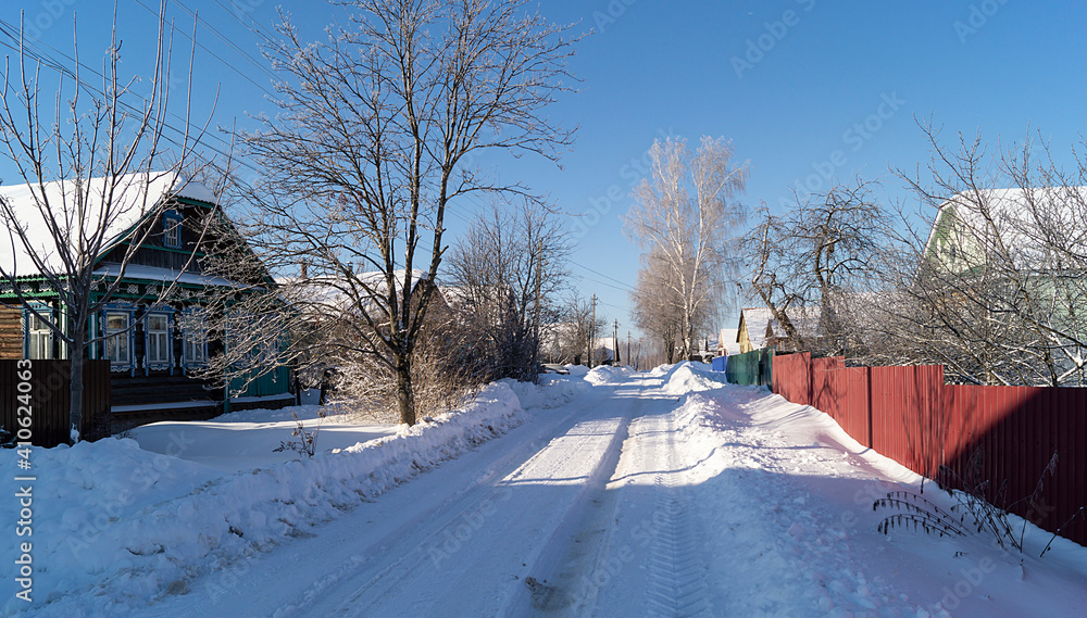 Street in village with expensive on background blue sky at winter length of time Street in village with expensive on background blue sky at winter length of time