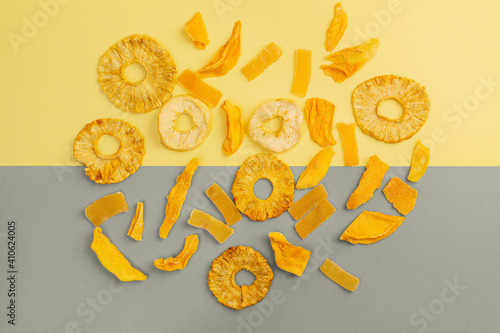 Assorted fruit jerky on yellow and gray background, top view