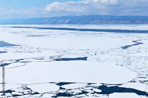 Baikal Lake in the spring. Top view of the ice drift in the Small Sea Strait. Beautiful water landscape. Change seasons. Natural spring background