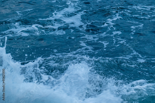 beautiful, blue sea with big, high waves, foam in a storm in the evening