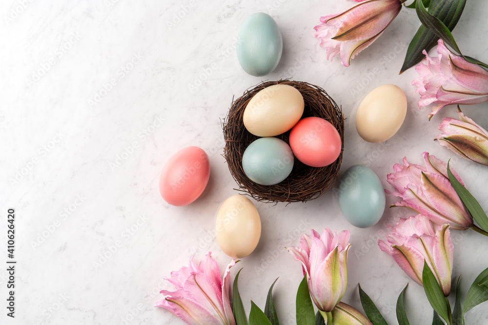 Colorful Easter eggs in the nest with pink Double Lily flower. Colorful Easter eggs in the nest with pink Double Lily flower.