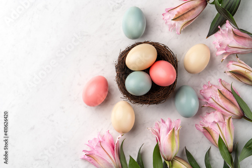 Colorful Easter eggs in the nest with pink Double Lily flower.