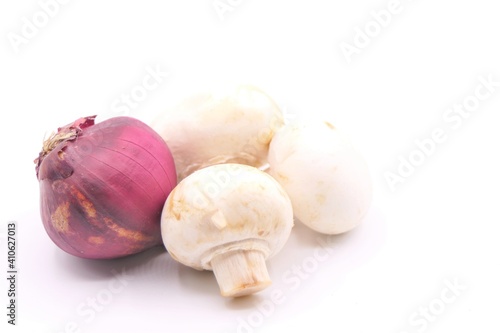 Red onion and mushrooms isolated at a white background high key