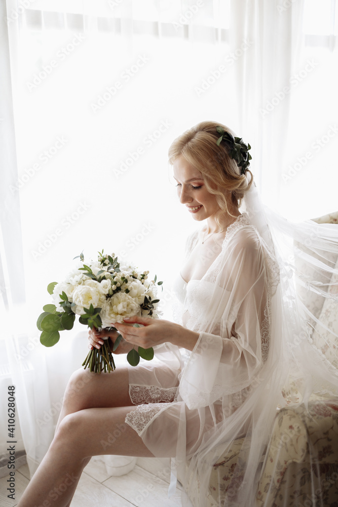 Wedding preparation. Blonde bride sitting in chair in luxury apartments Wedding preparation. Blonde bride sitting in chair in luxury apartments