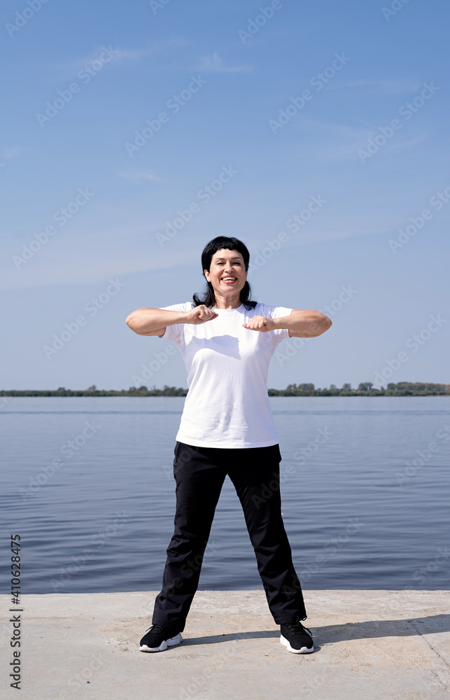 Active and happy senior woman exercising near the riverside Active and happy senior woman exercising near the riverside