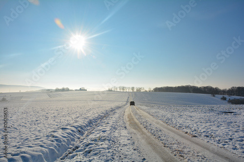 One  car on a snowy road in the country with many snow © Claudia Evans 