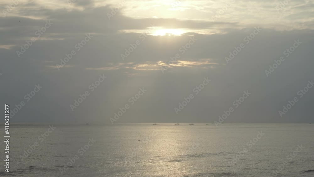 Fishermen in fishing boats fish at sea in the early morning sunrise, Bali Indonesia Fishermen in fishing boats fish at sea in the early morning sunrise, Bali Indonesia