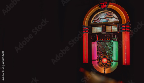 Retro jukebox on black background photo