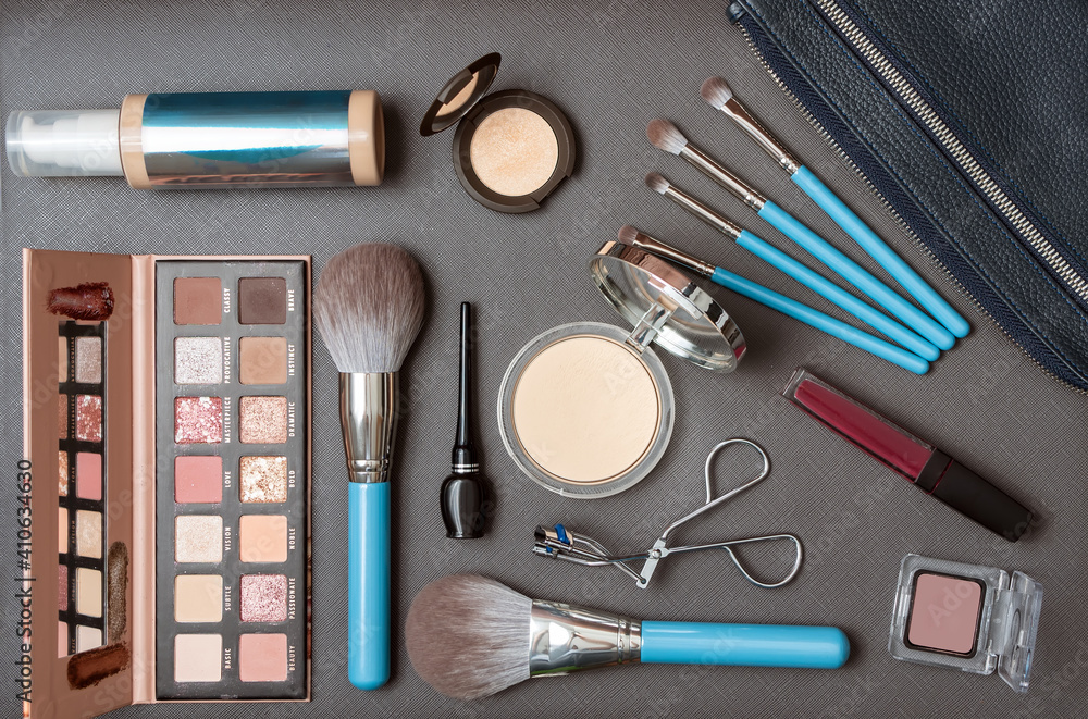 Set of decorative cosmetics and makeup set over the dark background. Top view. Cosmetics set. Flat lay. Close-up. Set of decorative cosmetics and makeup set over the dark background. Top view. Cosmetics set. Flat lay. Close-up.