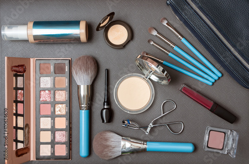 Set of decorative cosmetics and makeup set over the dark background. Top view. Cosmetics set. Flat lay. Close-up.