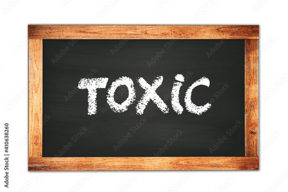 TOXIC text written on wooden frame school blackboard. TOXIC text written on wooden frame school blackboard.