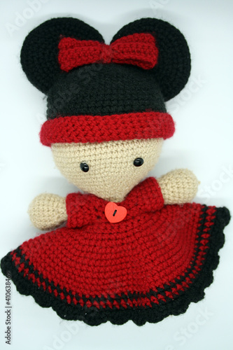 A doll made of yarn on a white background.