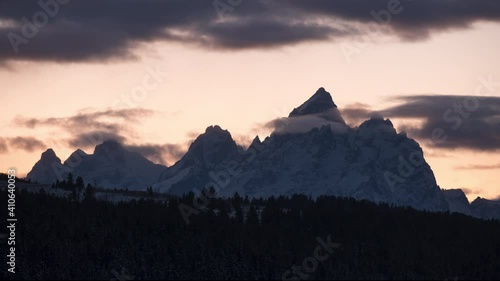 Timelapse of Grand Teton National Parks' famous Grand Teton Range right after sunset with clouds passing through.