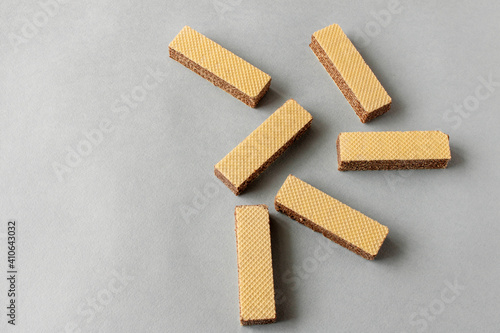 Several wafers with chocolate on a light background. Selective focus