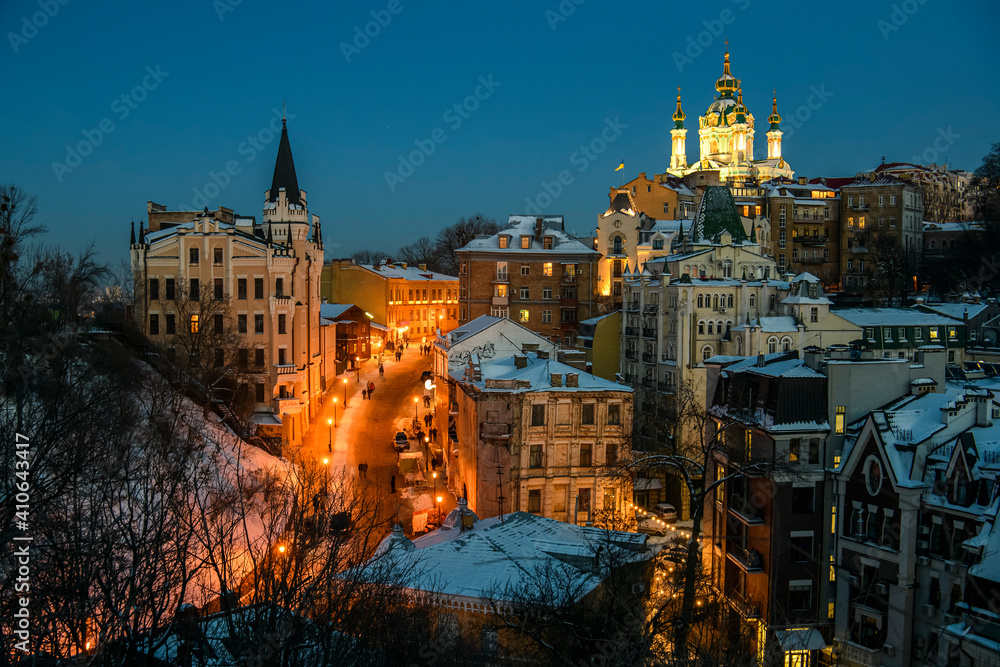 Evening winter view of Andriyivskyy Uzviz Descent with Saint Andrew's Church in the background. Kyiv, Ukraine.