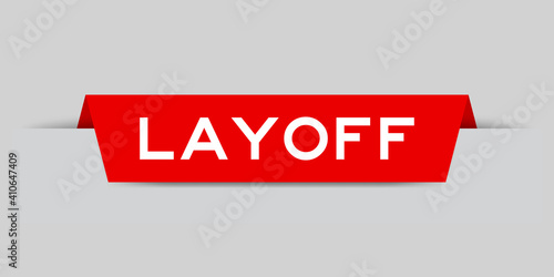 Red color inserted label with word layoff on gray background