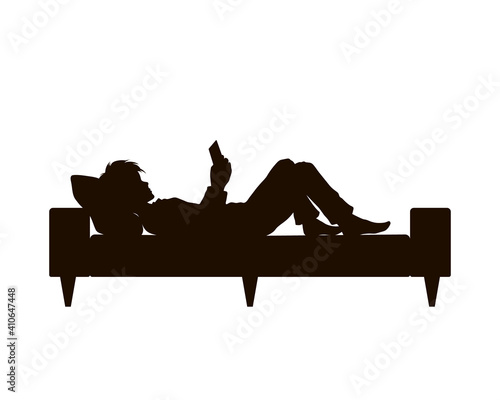 Black silhouette of boy lying with phone. Teenager resting on sofa. Young man watching mobile. Guy with tablet on bed