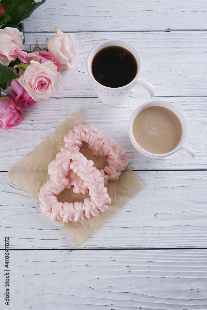 Two pink hearts made from meringues and coffee Two pink hearts made from meringues and coffee