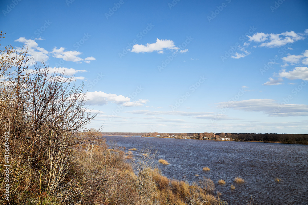 High water on a river or on a lake in sunny spring day
