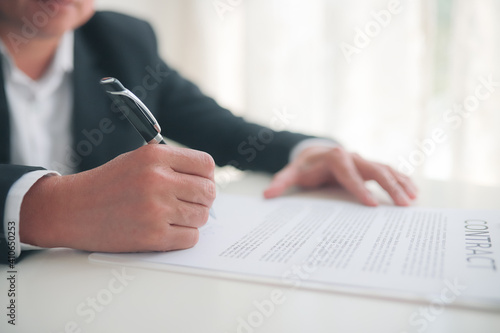 Partner Business  signing contractpaper  for service and law, 
Business owners shake hands to agree to work.Partners hold hands to accept work.Businessman feedback document concept photo