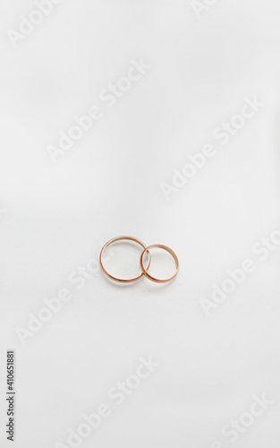 Two golden wedding rings on white background