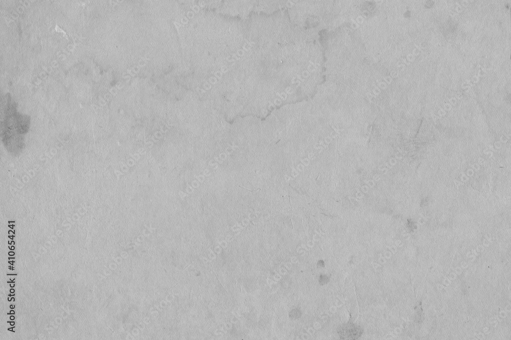 Cardboard gray texture close-up. Light old paper background. Grunge concrete wall. Vintage blank wallpaper.