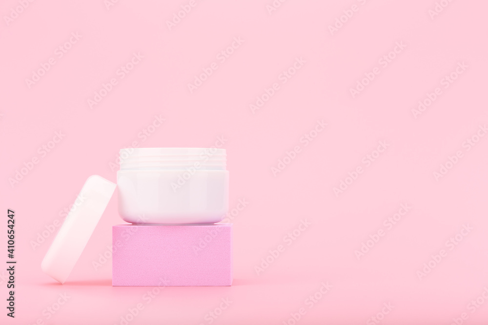 White opened cosmetic jar with cream, scrub or mask for face or hair on pink pedestal against pink background with copy space. Beauty products concept White opened cosmetic jar with cream, scrub or mask for face or hair on pink pedestal against pink background with copy space. Beauty products concept