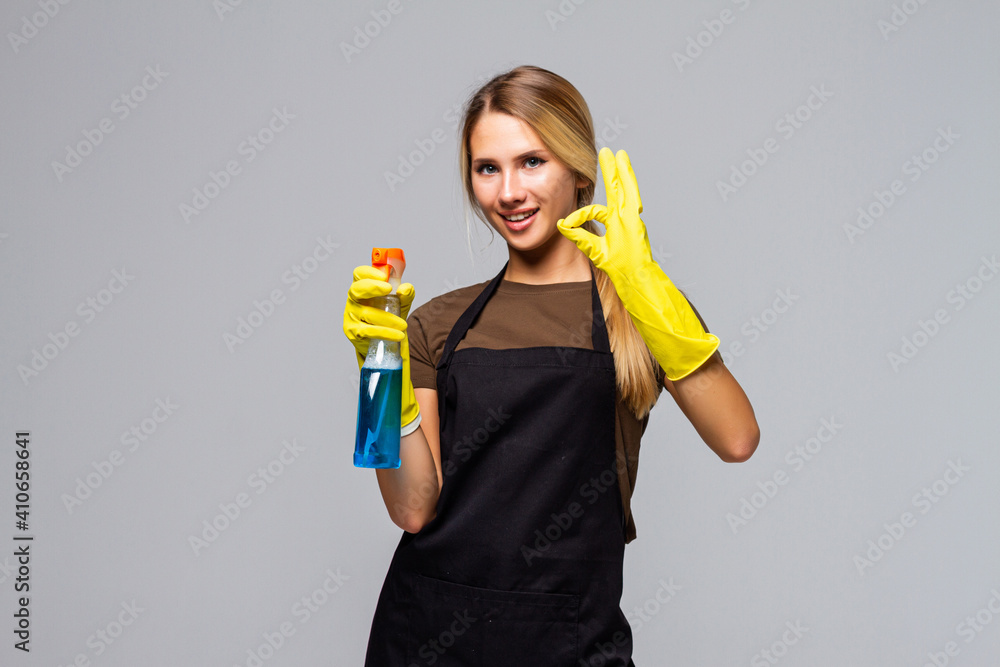 Cheerful housekeeper woman showing ok sign as great cleaning services concept on white background Cheerful housekeeper woman showing ok sign as great cleaning services concept on white background