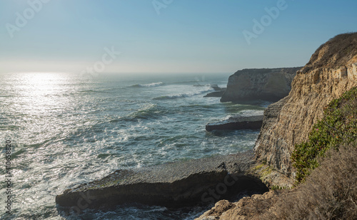 Beautiful seascape of the Pacific coast in California, waves, rocks, sky, sun. Concept, perfect postcard and guide.