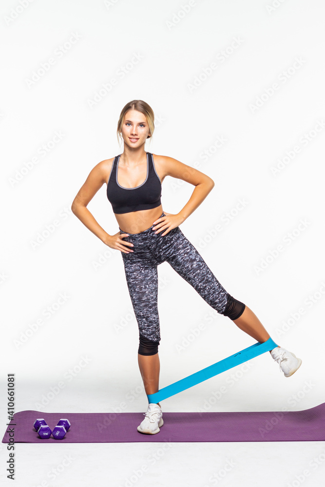 Fitness woman exercising fitness resistance bands on mat isolated on white background Fitness woman exercising fitness resistance bands on mat isolated on white background