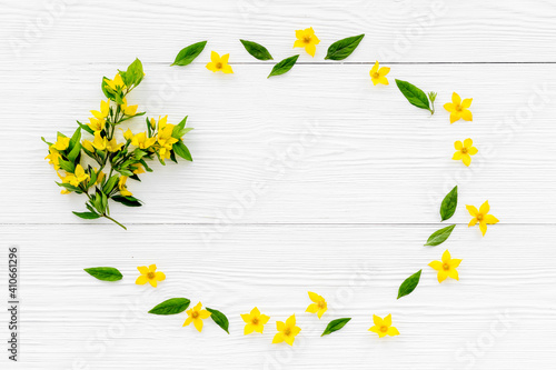 Blank greeting card with yellow flowers, top view. Floral background