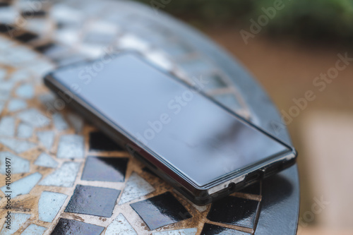 Smartphones on the table outside.